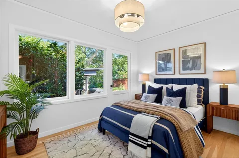 a bedroom with bed and a potted plant