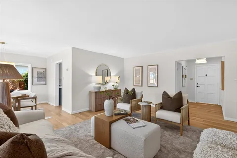 a living room with furniture ceiling fan and a rug