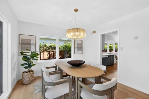 a view of a dining room with furniture and a potted plant