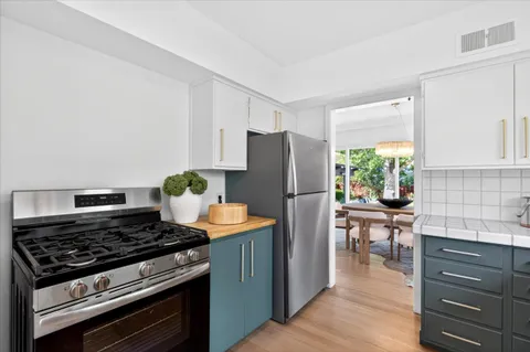 a kitchen with stainless steel appliances granite countertop a stove and a refrigerator