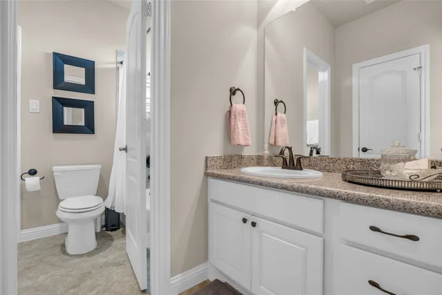 a bedroom with a bed chandelier and a window