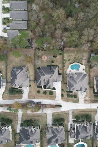 a aerial view of a house with a yard and garage