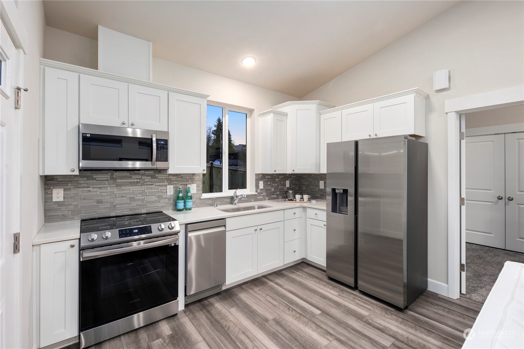 10980 Southeast 165th Street Renton, WA 98055 - Photo 14 of 16 a kitchen with stainless steel appliances a stove a sink and a refrigerator