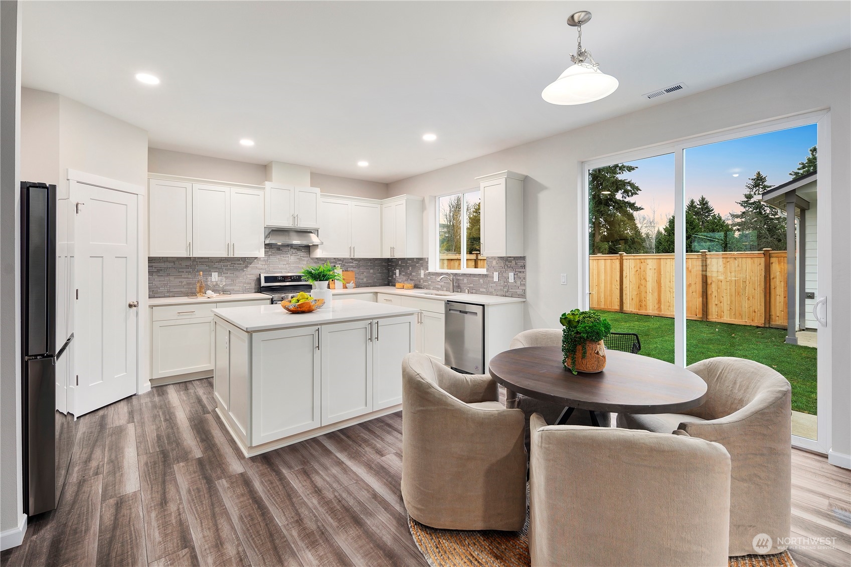 10980 Southeast 165th Street Renton, WA 98055 - Photo 6 of 16 a open kitchen with stainless steel appliances granite countertop a refrigerator a sink dishwasher a stove and white cabinets with wooden floor