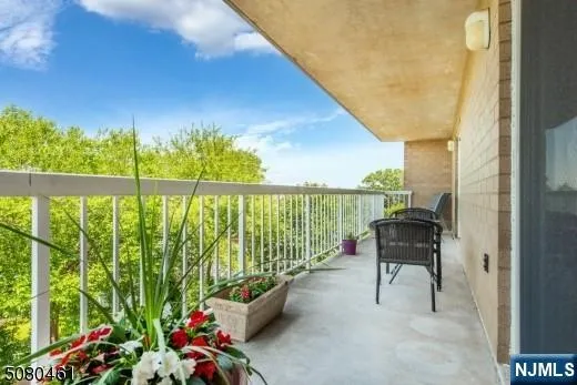 a view of a chairs and table in the balcony