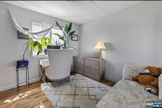 a room with a couch a chandelier and a window