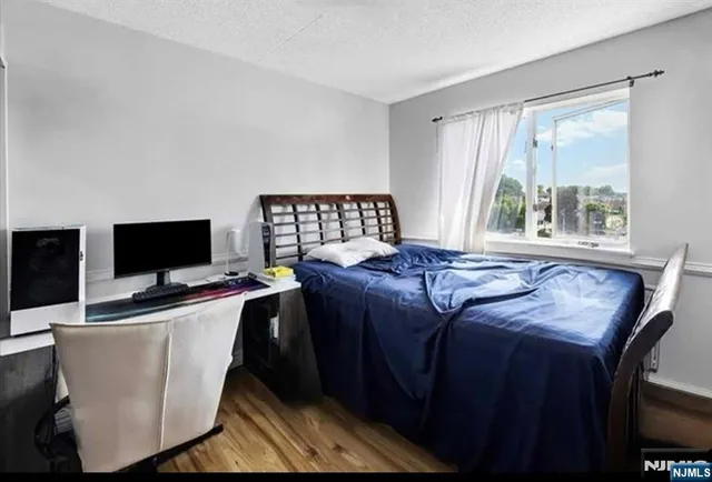 a bed room with a bed and a television