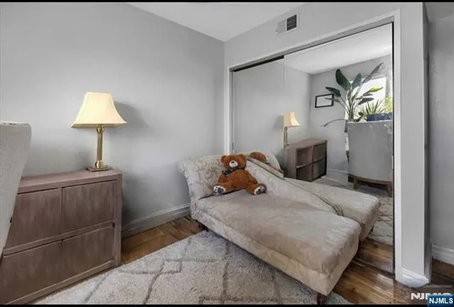 a bedroom with a bed and a lamp on table