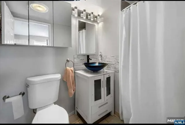 a bathroom with a toilet a sink and a window