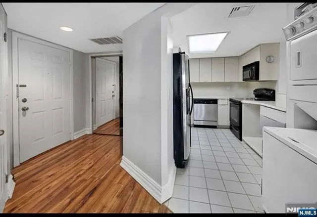 a kitchen with stainless steel appliances a refrigerator and a stove top oven