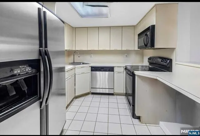 a kitchen with a stove a sink and a microwave