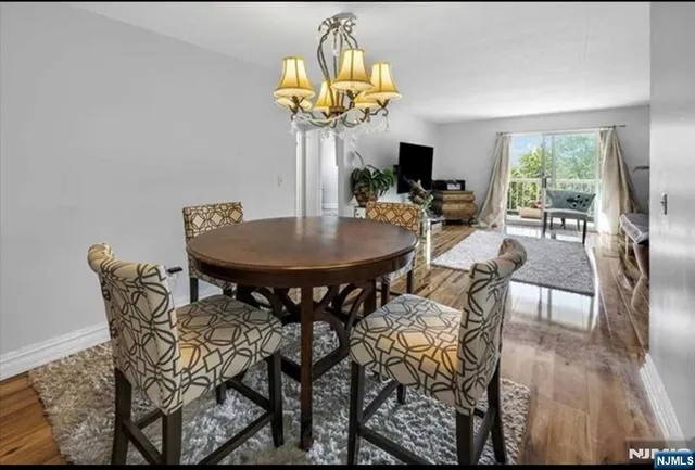 a view of a dining room with furniture and a potted plant