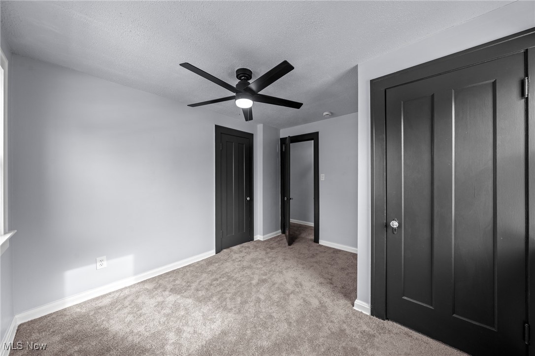 1193 Mayfield Ridge Road Cleveland, OH 44124 - Photo 22 of 35 Unfurnished bedroom featuring carpet, a textured ceiling, and a ceiling fan