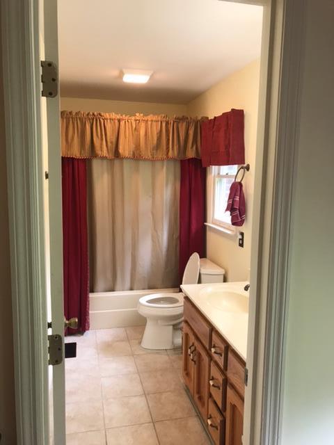 5070 Joe Peay Road Spring Hill, TN 37174 - Photo 4 of 25 a bathroom with a sink a toilet and shower curtain