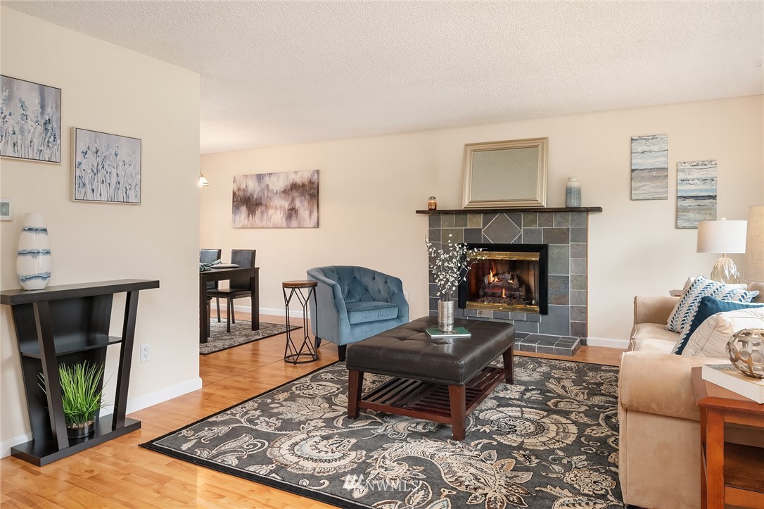 21814 6th Avenue West Bothell, WA 98021 - Photo 3 of 23 a living room with furniture a rug and a fireplace