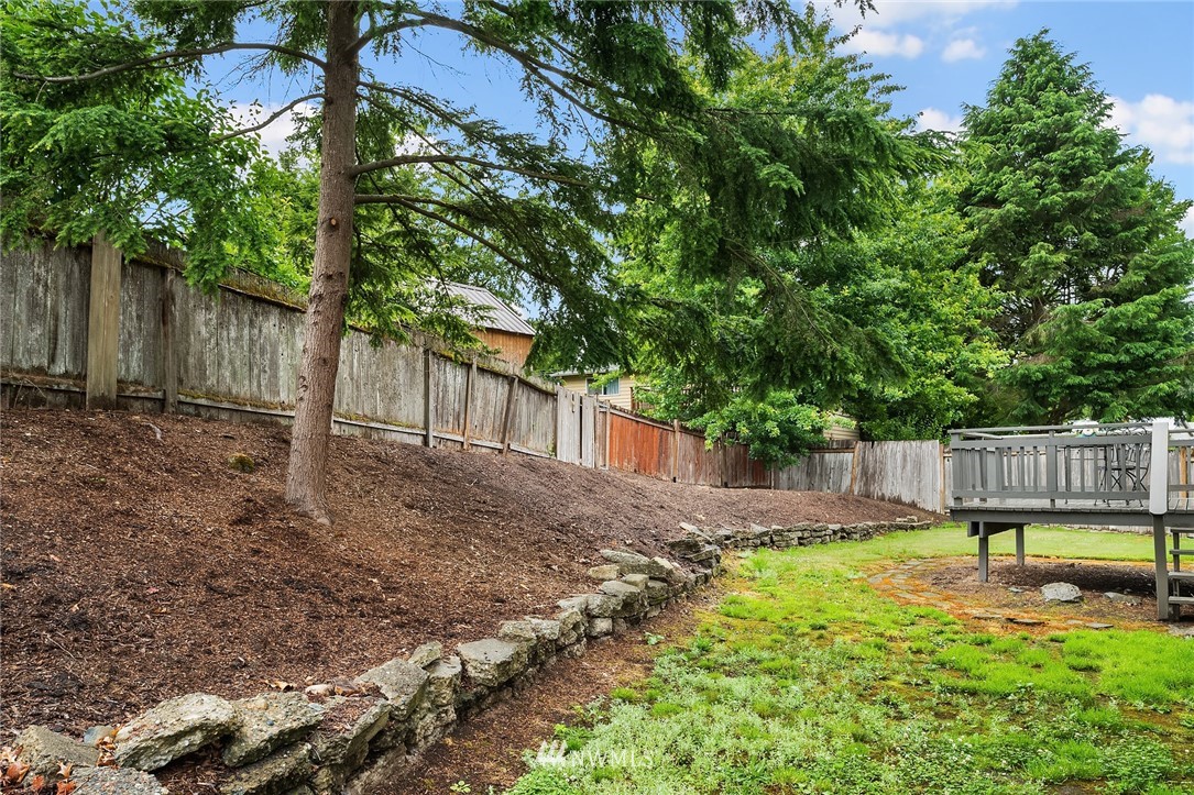 21814 6th Avenue West Bothell, WA 98021 - Photo 22 of 23 a backyard of a house with lawn chairs plants and large tree