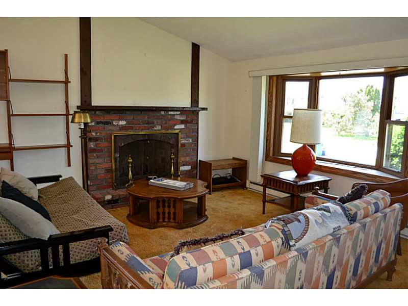27 Bristol Road Narragansett, RI 02882 - Photo 4 of 10 Living Room. CLEAN! Sunny Living area with bay window and brick fireplace.