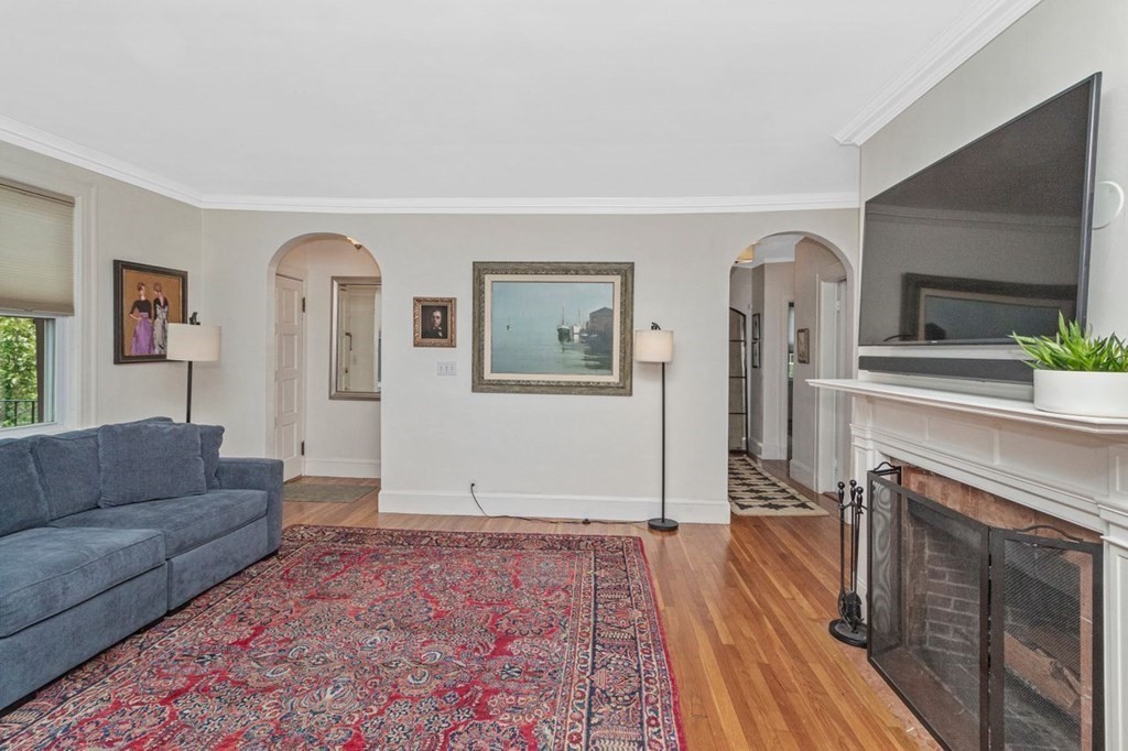 50 Crosby Road, Unit 1 Chestnut Hill, MA 02467 - Photo 4 of 27 a living room with furniture and a fireplace