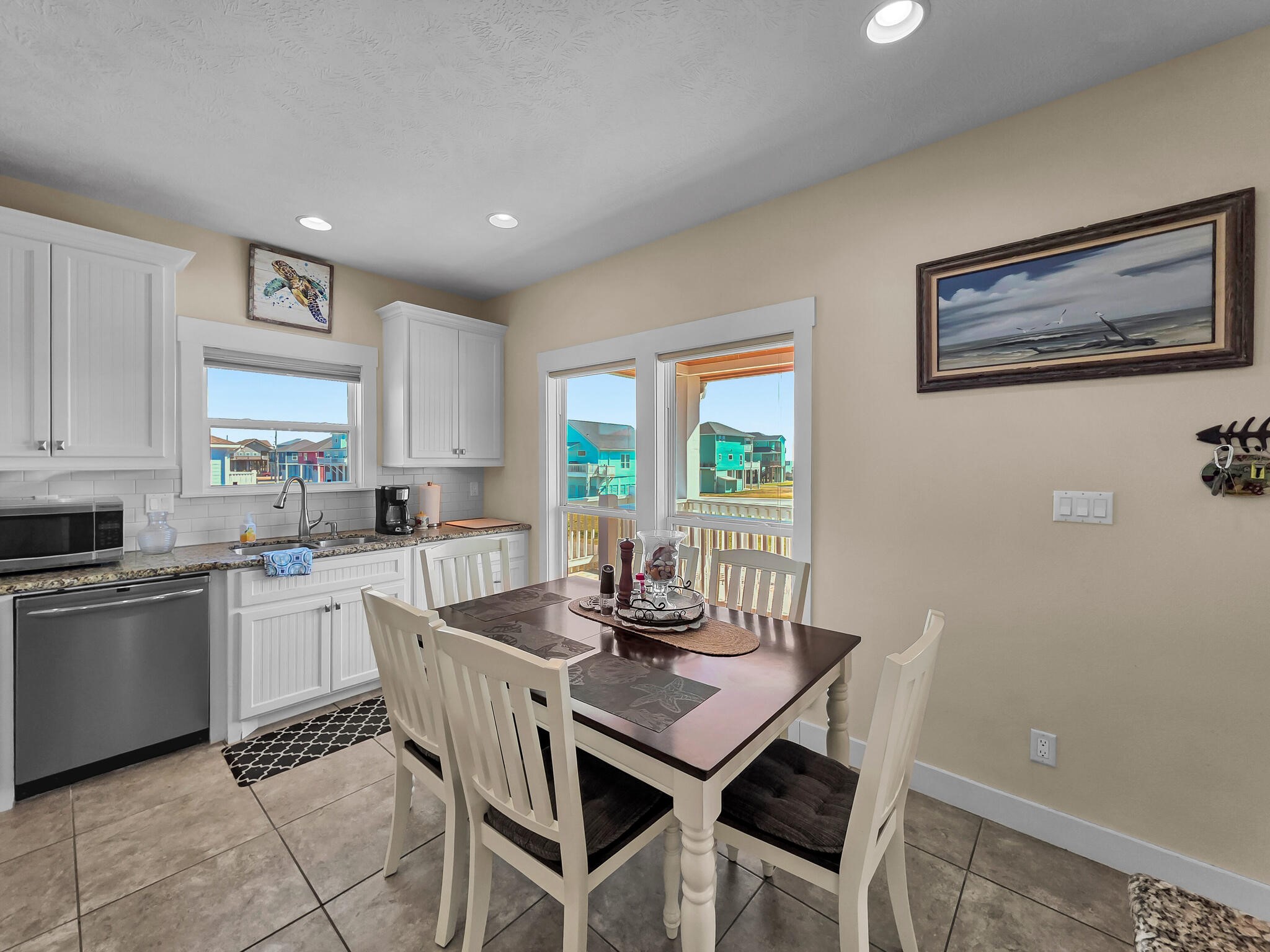 2383 Sandpiper Crystal Beach, TX 77650 - Photo 11 of 48 a kitchen with a dining table chairs and large window