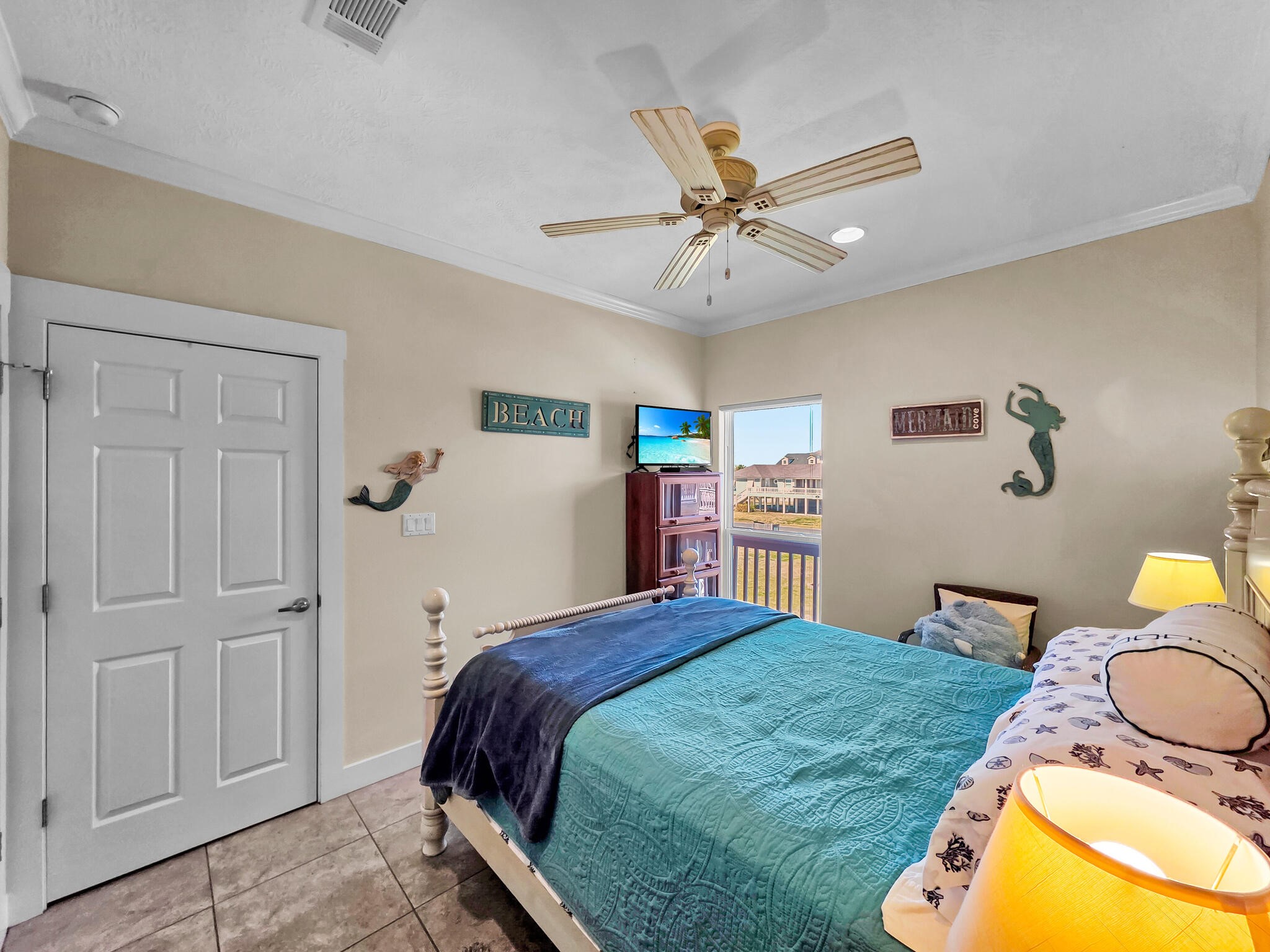 2383 Sandpiper Crystal Beach, TX 77650 - Photo 18 of 48 a bedroom with a bed and a chandelier