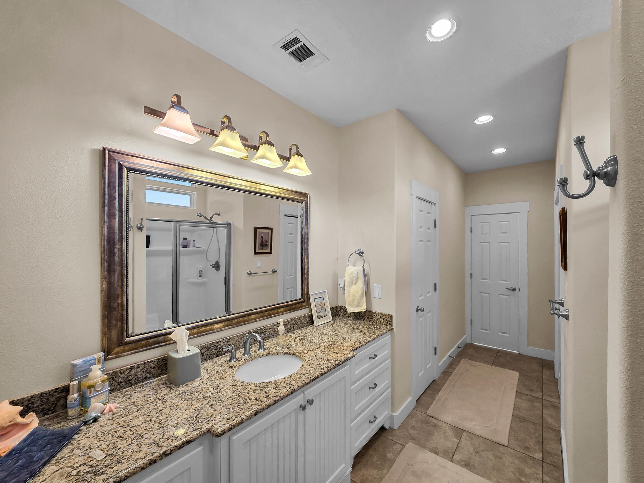 2383 Sandpiper Crystal Beach, TX 77650 - Photo 21 of 48 a bathroom with a granite countertop double vanity sink and a mirror