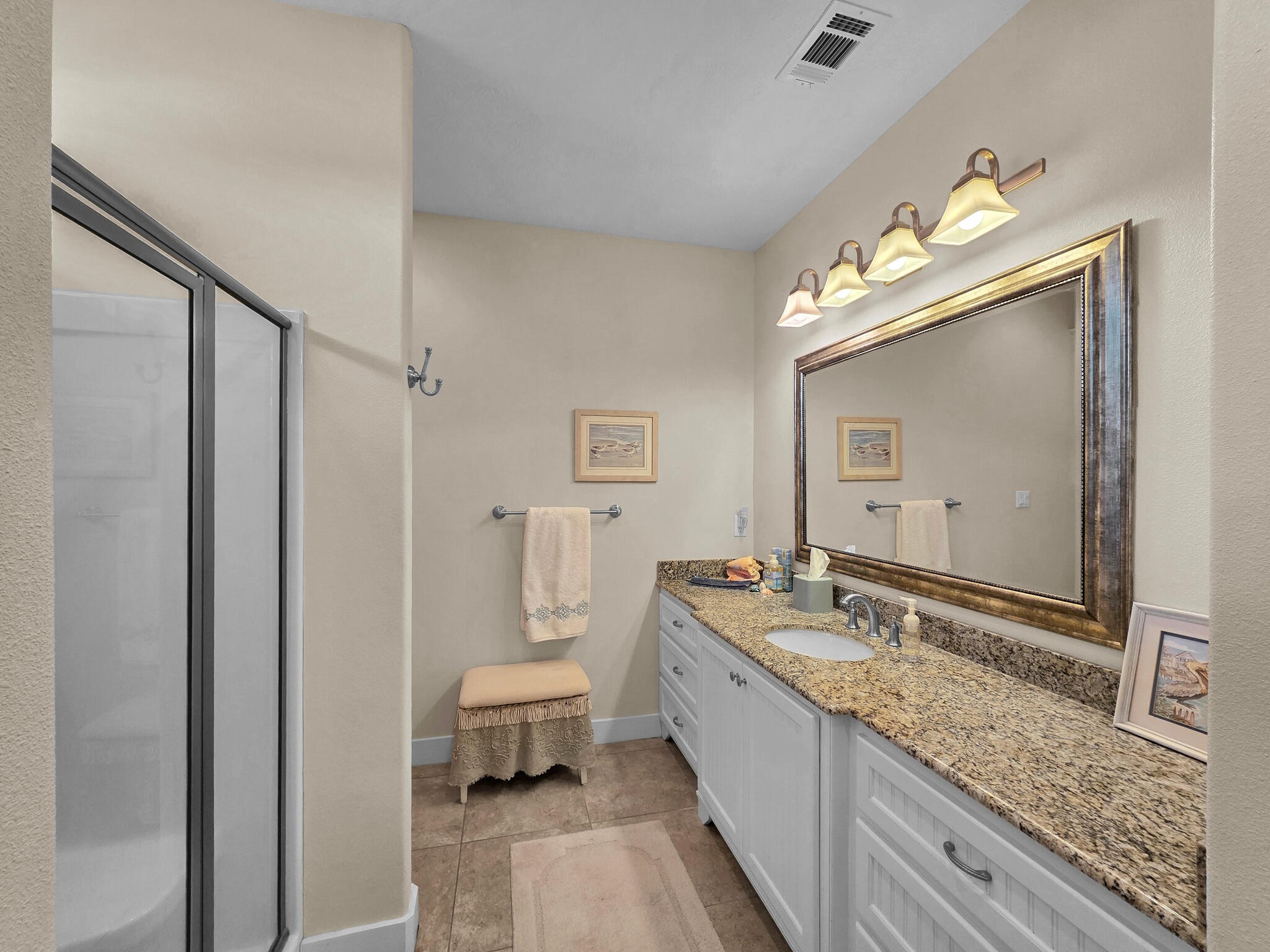 2383 Sandpiper Crystal Beach, TX 77650 - Photo 22 of 48 a spacious bathroom with a granite countertop sink mirror and a bathtub