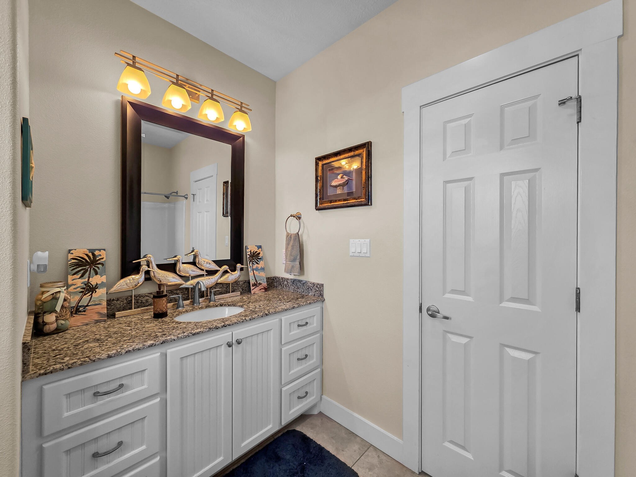 2383 Sandpiper Crystal Beach, TX 77650 - Photo 23 of 48 a bathroom with a double vanity sink and a mirror