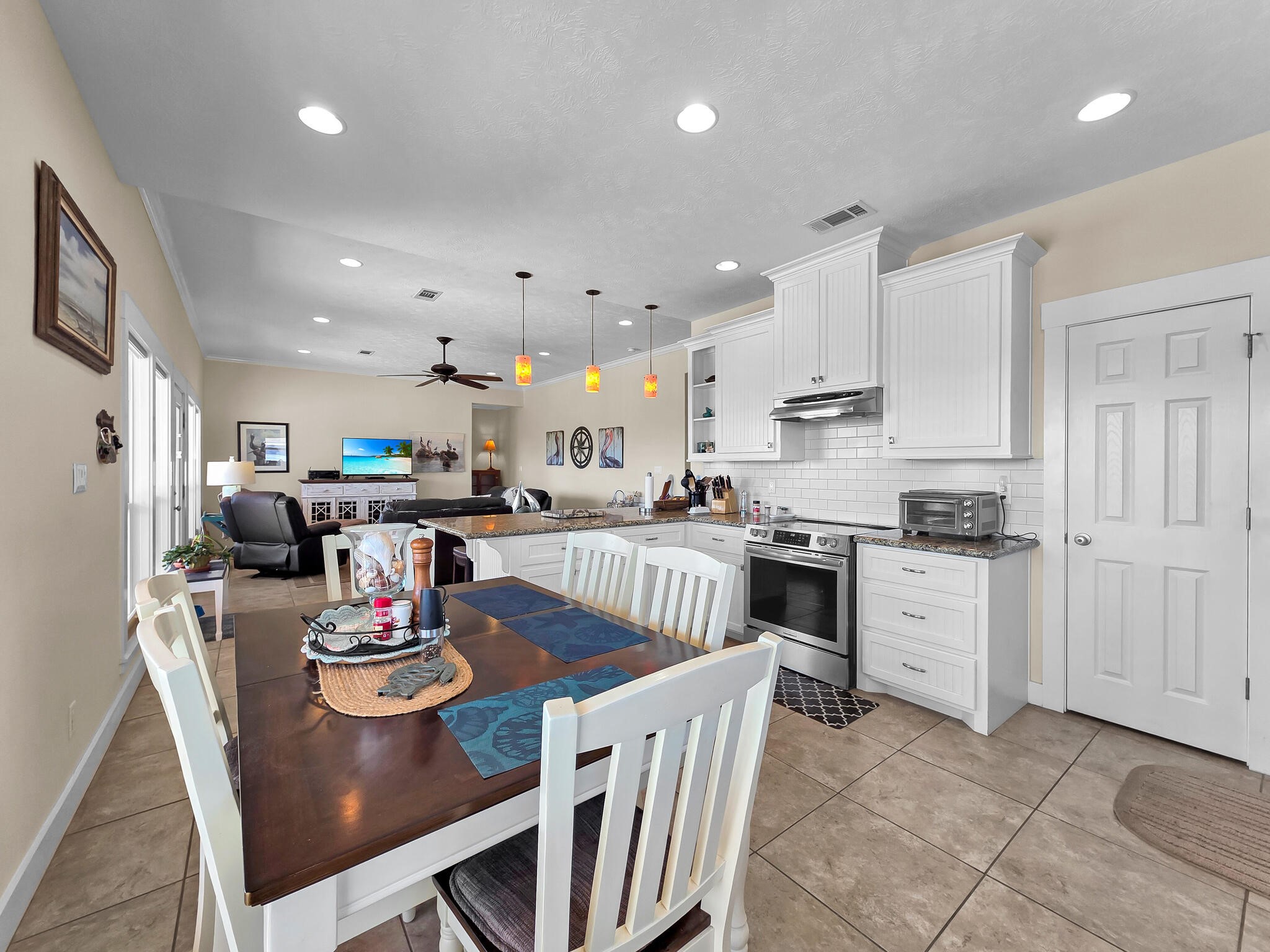 2383 Sandpiper Crystal Beach, TX 77650 - Photo 10 of 48 a kitchen with a dining table chairs stove refrigerator and cabinets