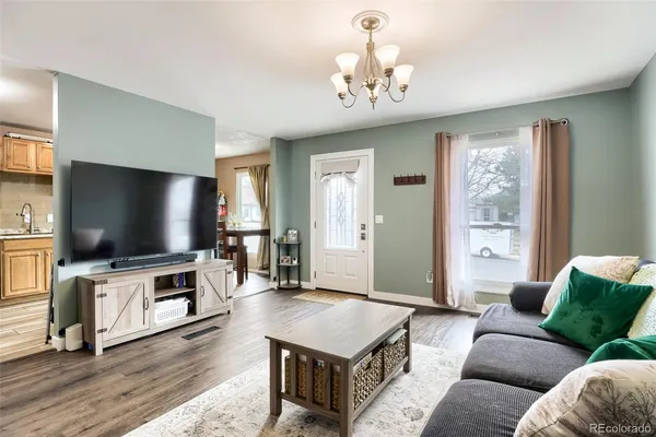 a living room with furniture a rug and a window