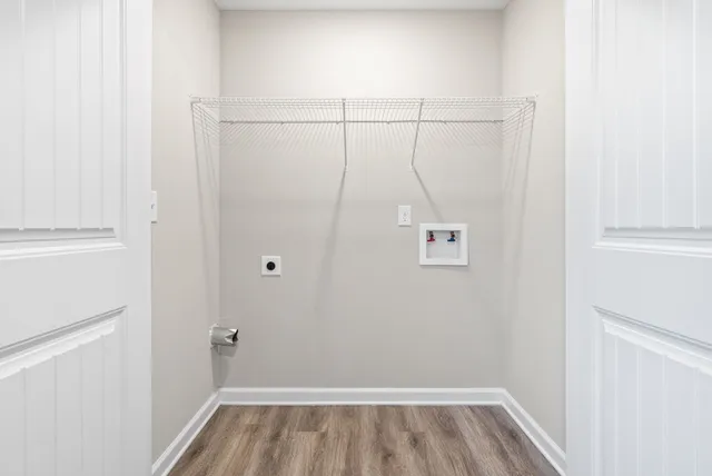 a view of a room with wooden floor