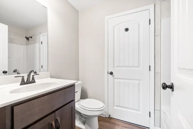 a bathroom with a sink toilet and shower