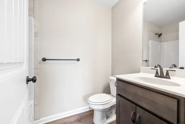 a bathroom with a sink a toilet and a mirror