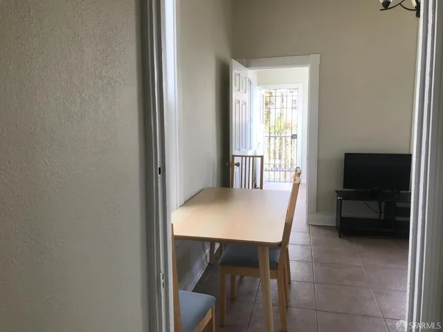 a view of a dining room with furniture and a chandelier