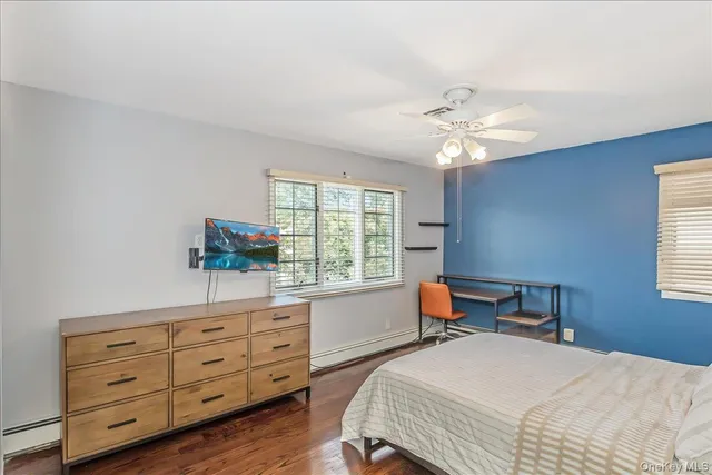 a bedroom with a bed dresser and a window