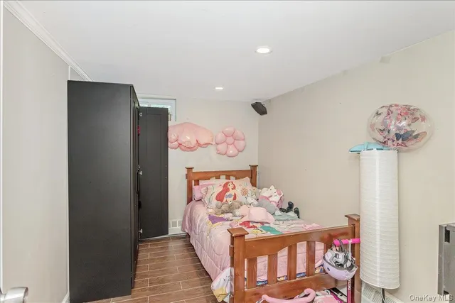 a bedroom with furniture and a wooden floor