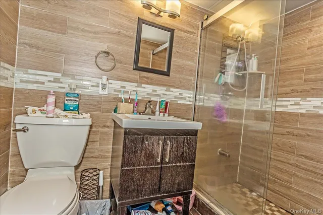 a bathroom with a sink toilet and shower