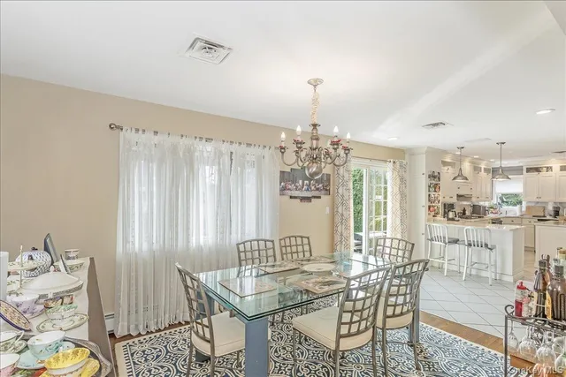 a view of a dining room with furniture and chandelier