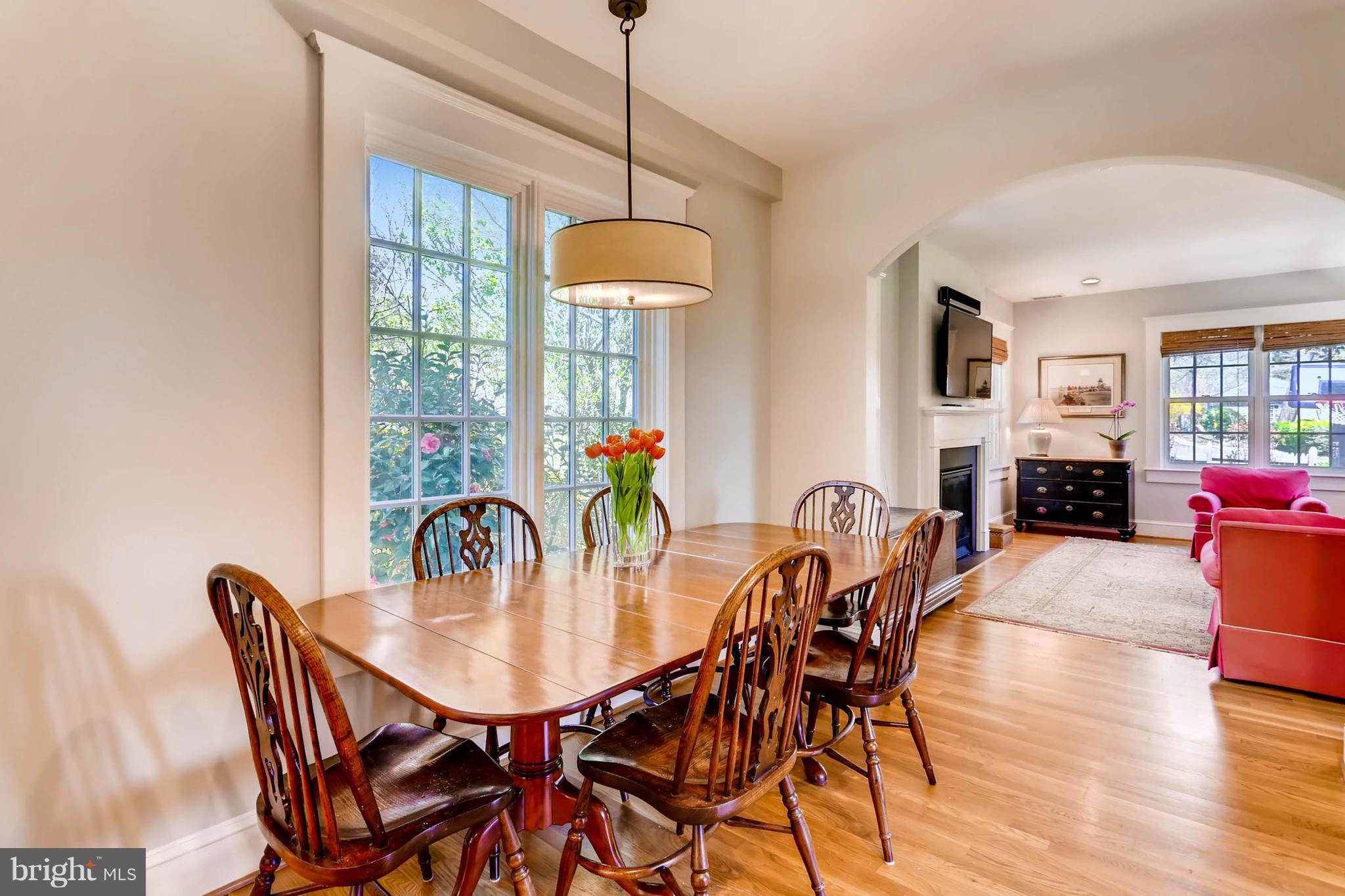 207 Oakdale Road Baltimore, MD 21210 - Photo 13 of 30 a dining room with furniture a chandelier and wooden floor