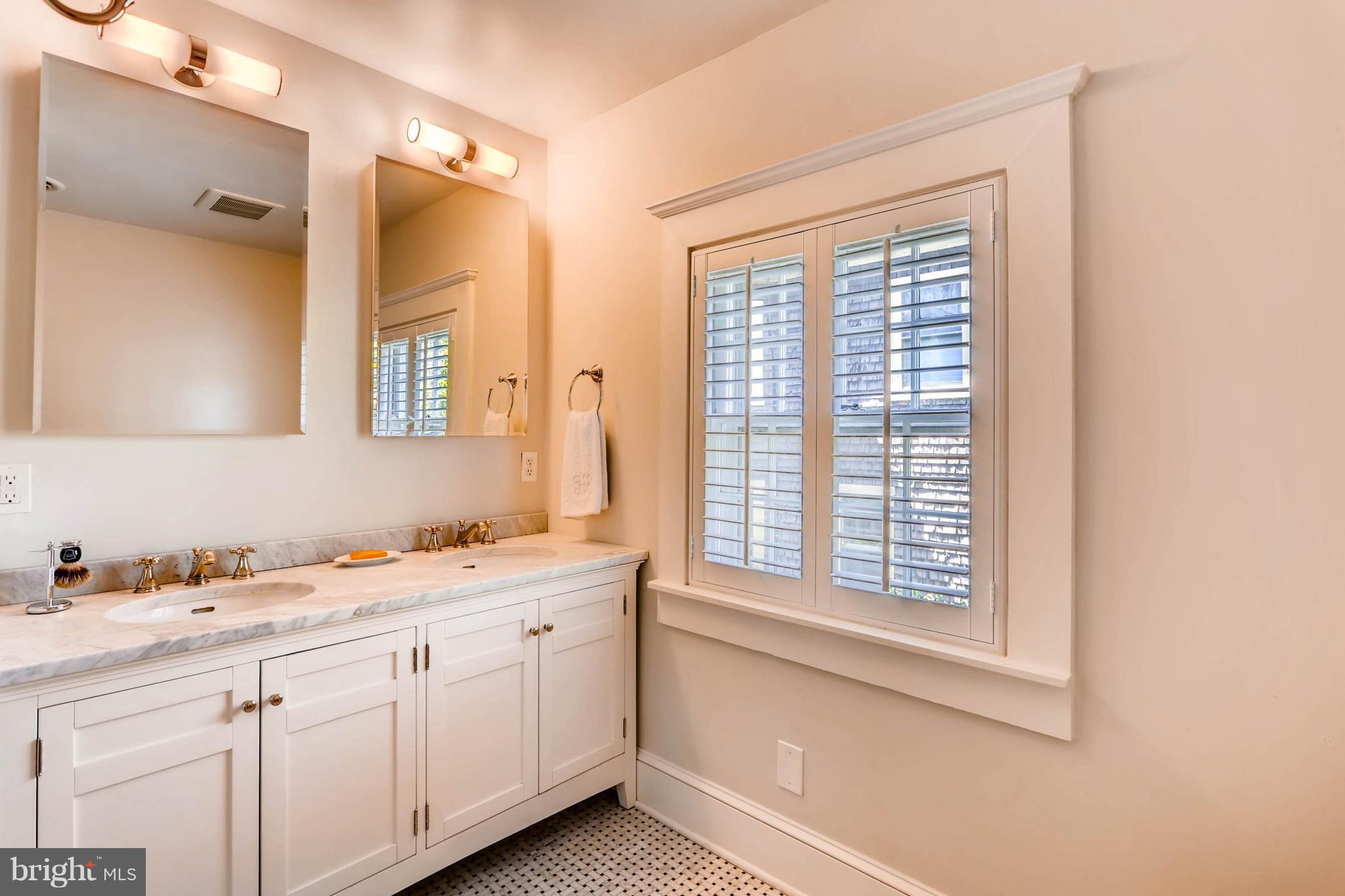 207 Oakdale Road Baltimore, MD 21210 - Photo 19 of 30 a bathroom with a sink and a window