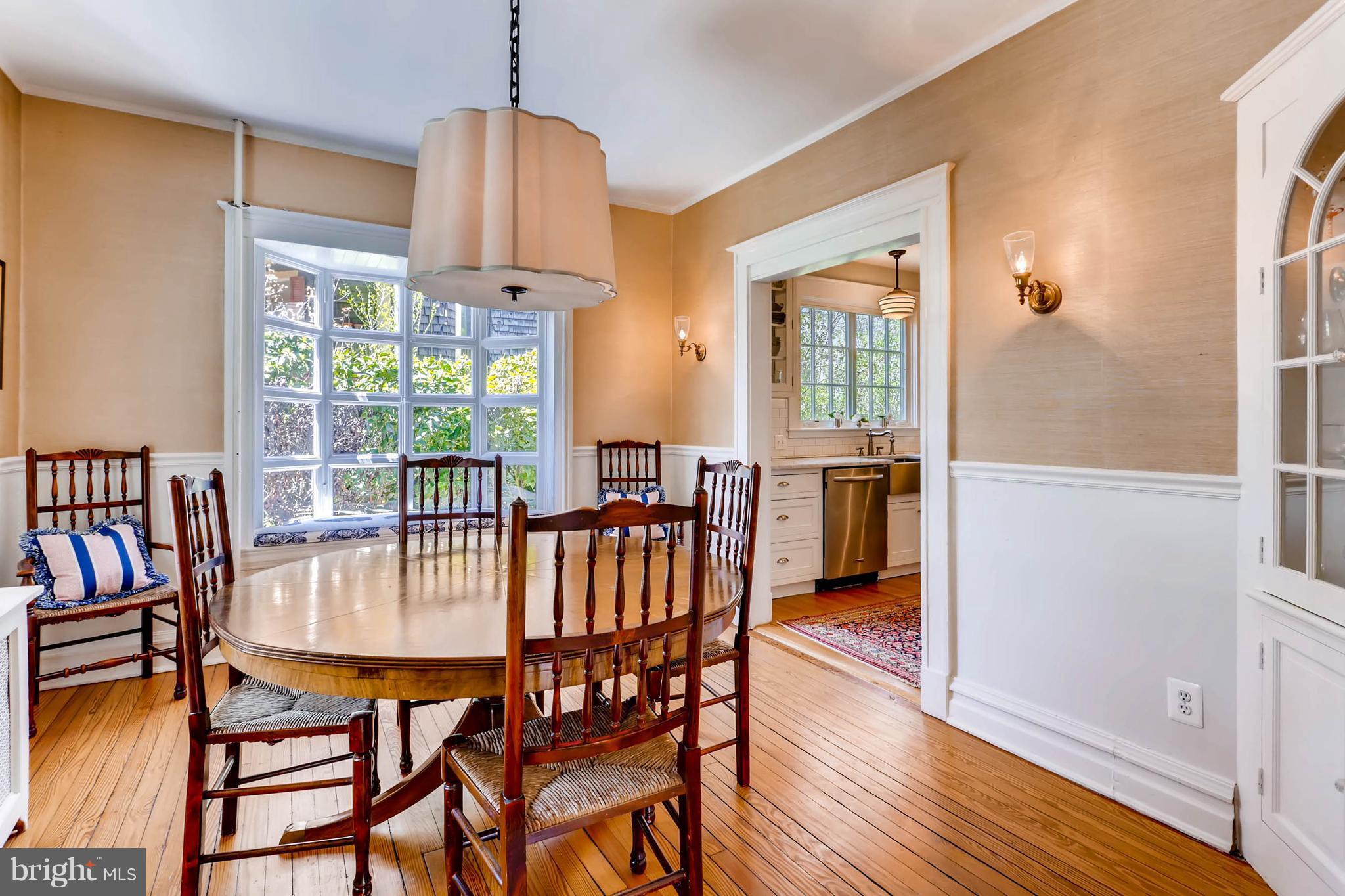 207 Oakdale Road Baltimore, MD 21210 - Photo 9 of 30 a dining room with furniture a chandelier and wooden floor
