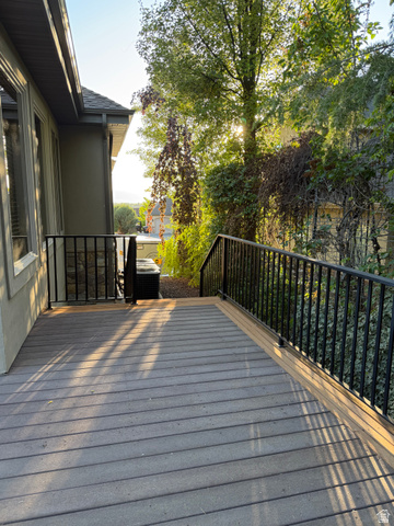 4536 North 475 East Provo, UT 84604 - Photo 55 of 65 Outdoor deck featuring composite decking, black metal railing, and mature landscaping