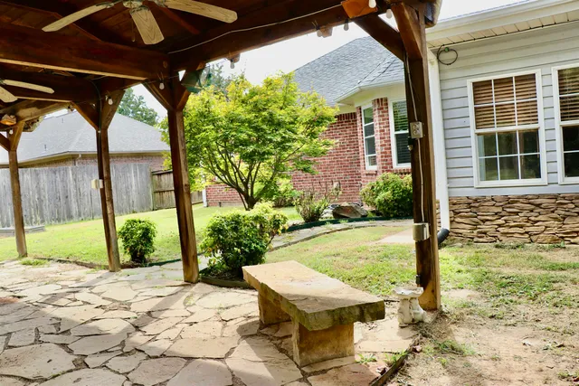 a kitchen with granite countertop stainless steel appliances and brick cabinets
