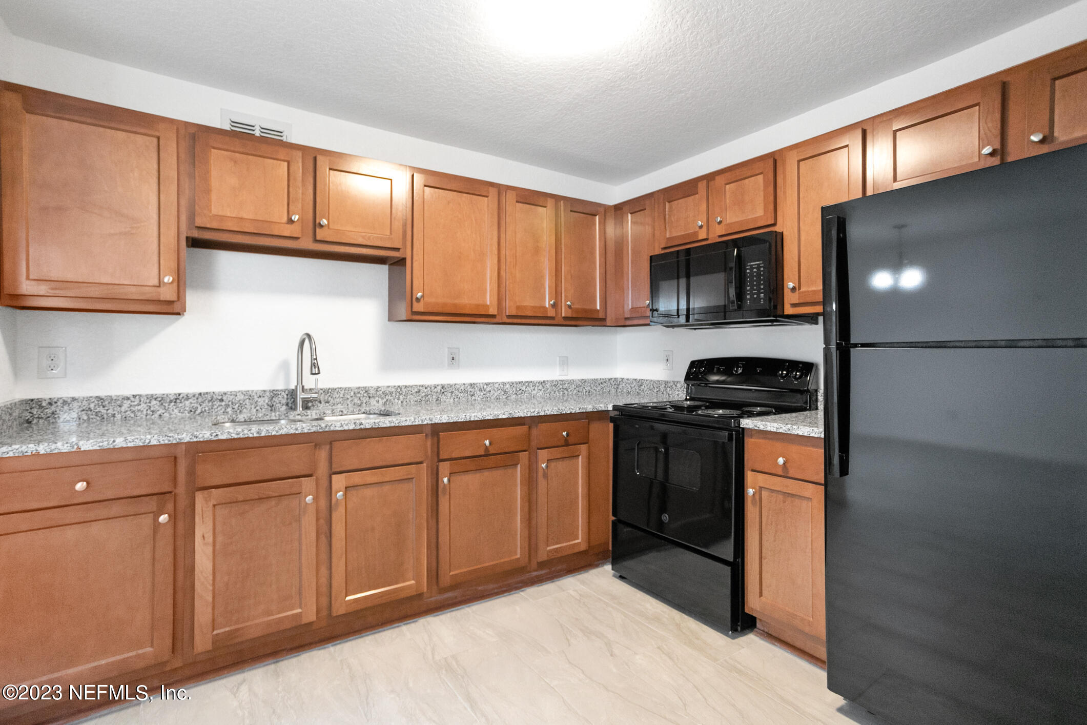 3616 Effee Street Jacksonville, FL 32209 - Photo 11 of 18 a kitchen with stainless steel appliances granite countertop a stove sink and cabinets