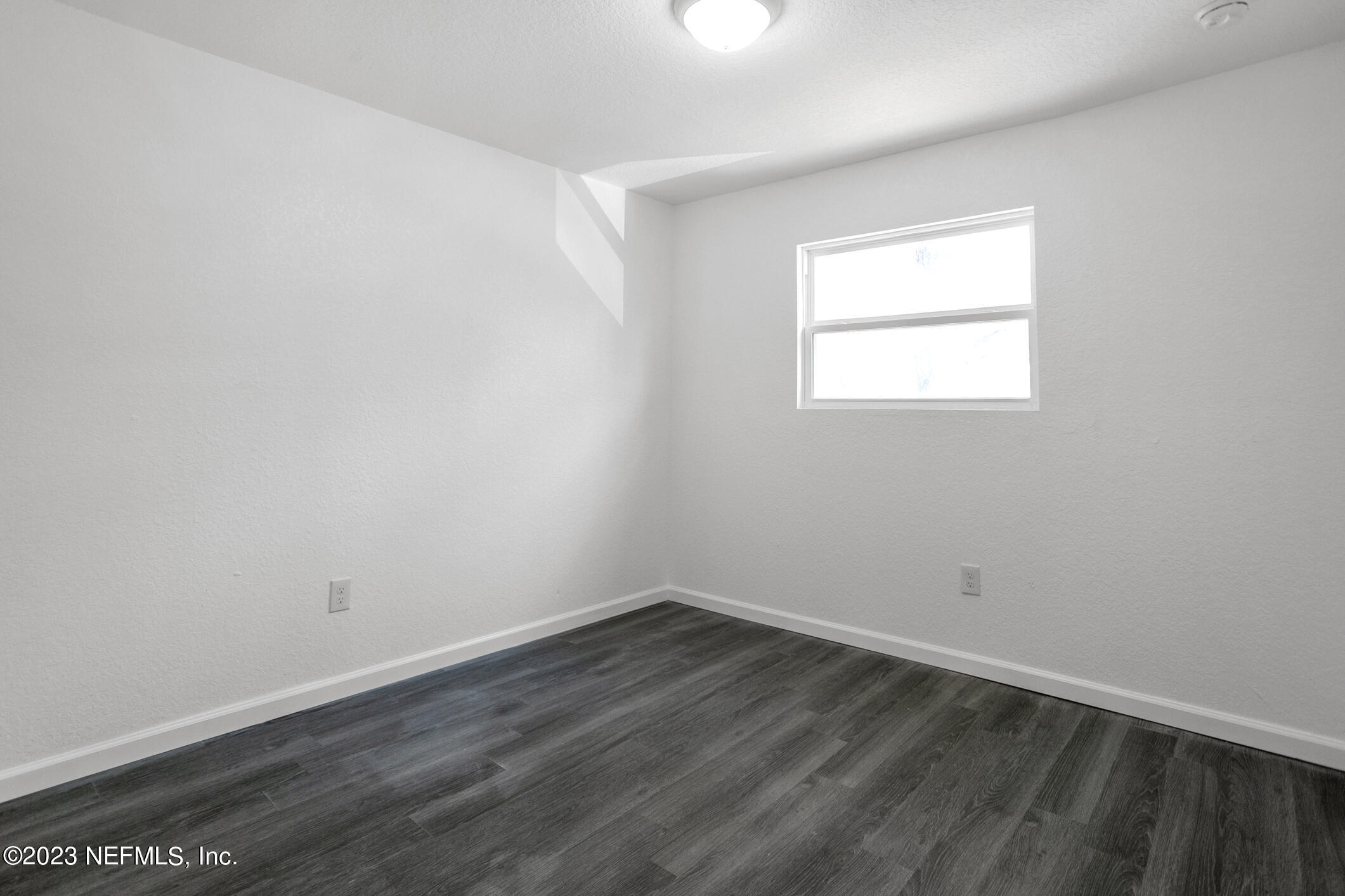 3616 Effee Street Jacksonville, FL 32209 - Photo 12 of 18 wooden floor in an empty room with a window