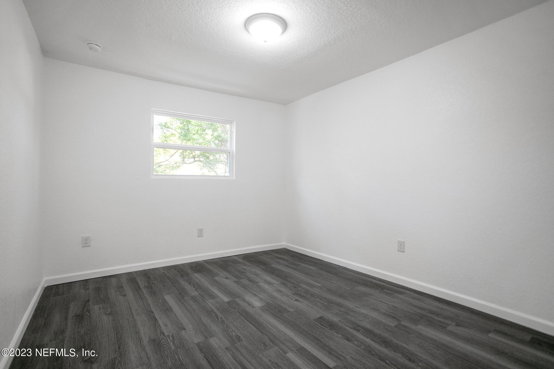 3616 Effee Street Jacksonville, FL 32209 - Photo 13 of 18 an empty room with wooden floor and windows