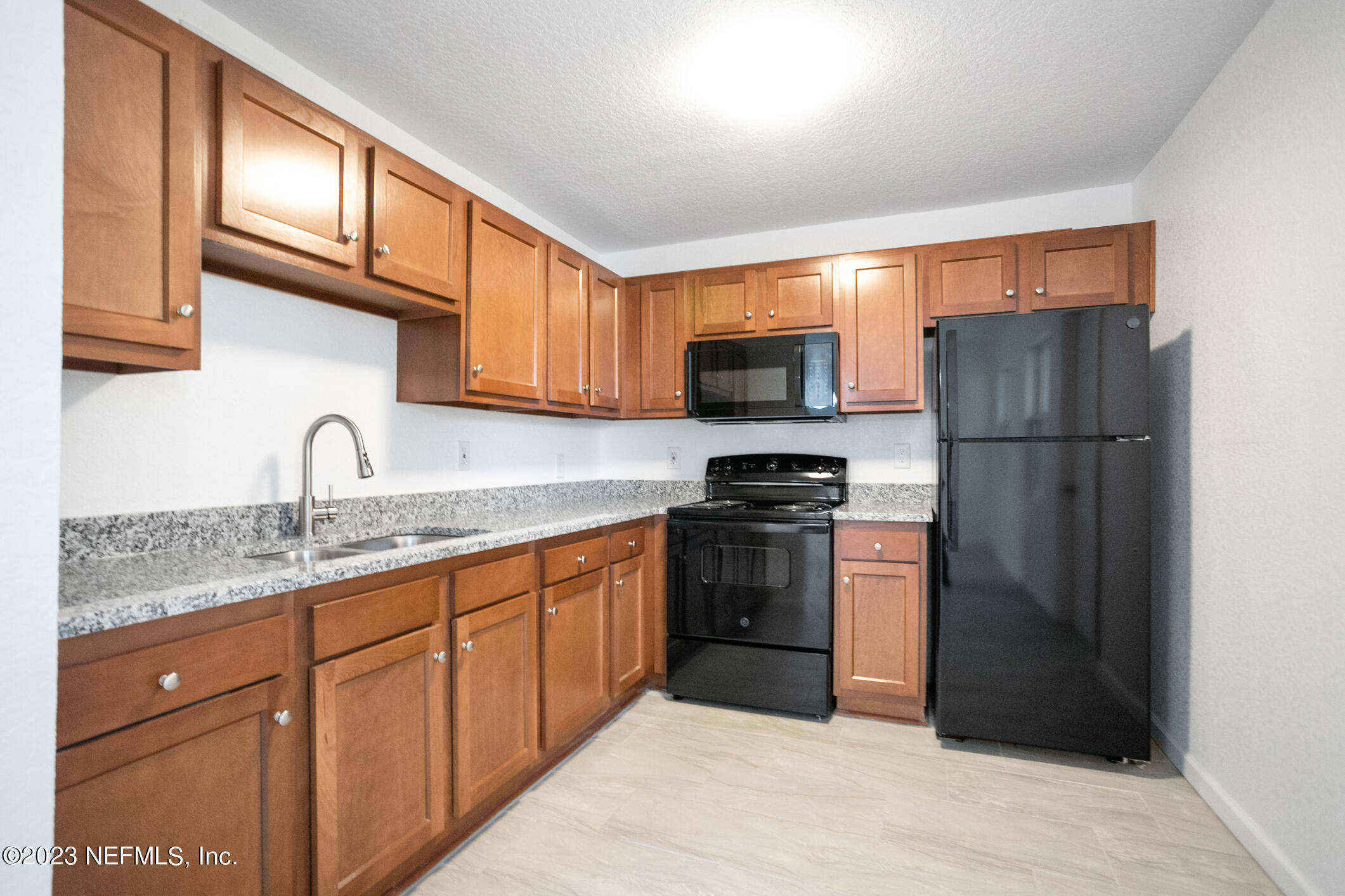 3616 Effee Street Jacksonville, FL 32209 - Photo 10 of 18 a kitchen with stainless steel appliances granite countertop a refrigerator and a sink