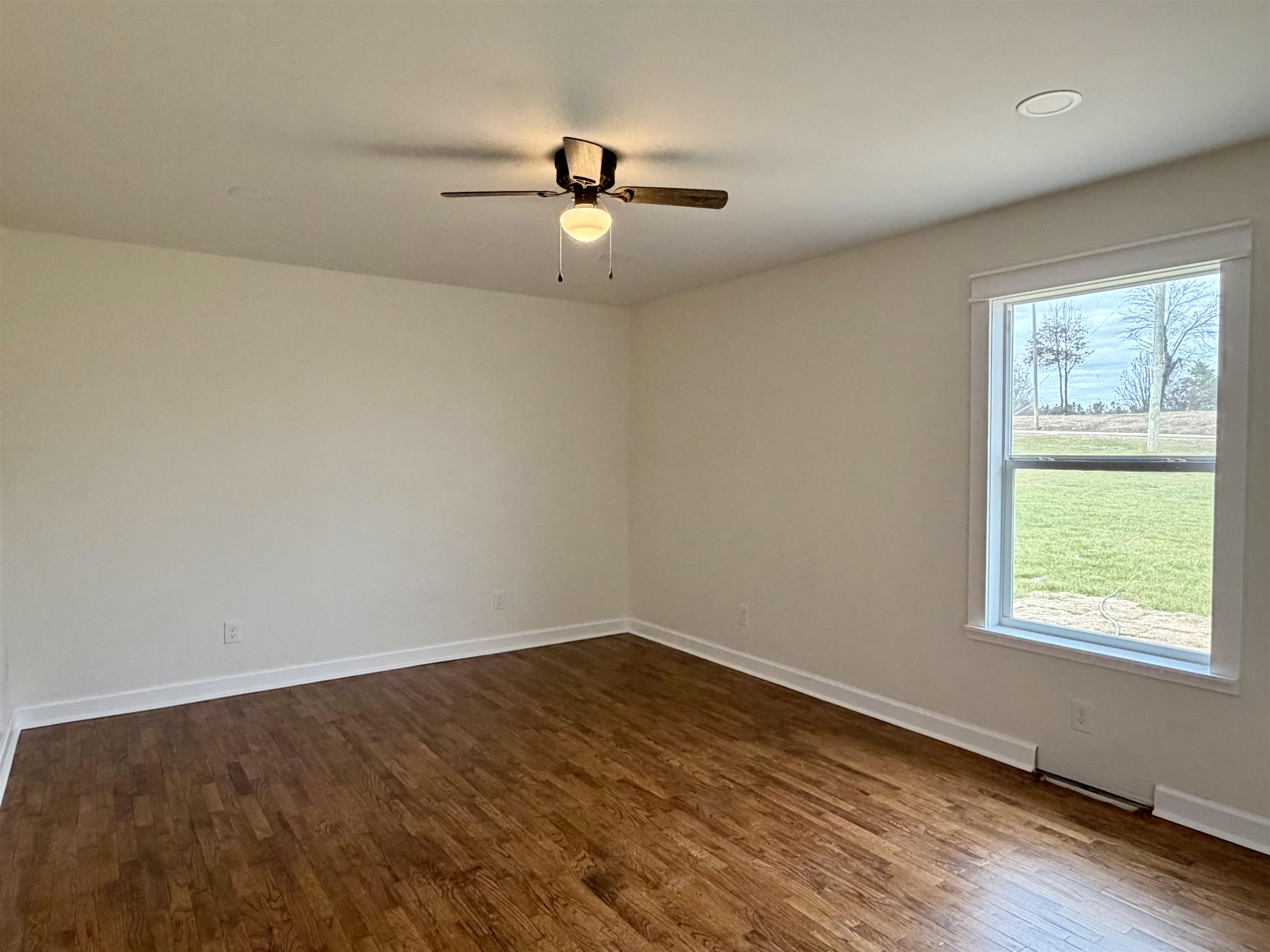 172 New Bethel Road Selmer, TN 38375 - Photo 23 of 30 wooden floor in an empty room with a window