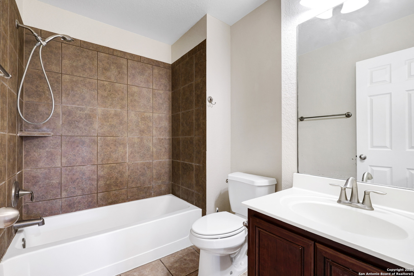 10410 Weser Lane Helotes, TX 78023 - Photo 15 of 22 a bathroom with a sink a toilet and a bathtub