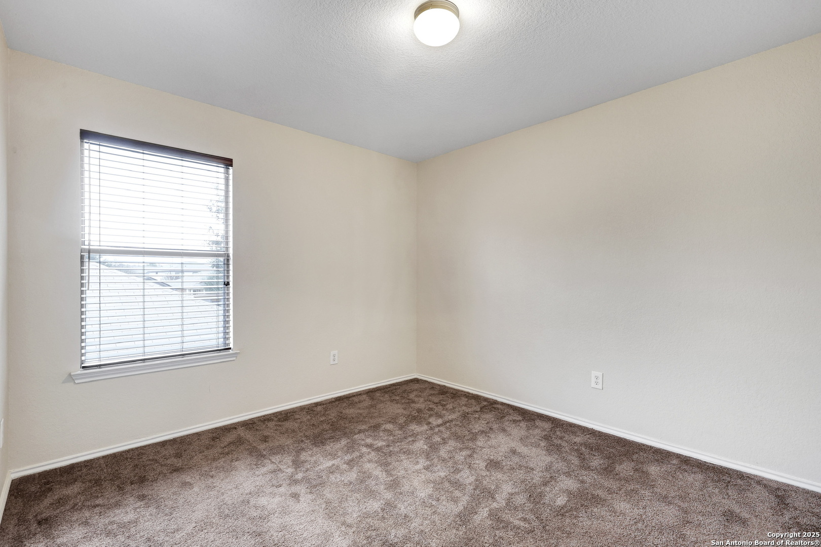 10410 Weser Lane Helotes, TX 78023 - Photo 16 of 22 an empty room with a window