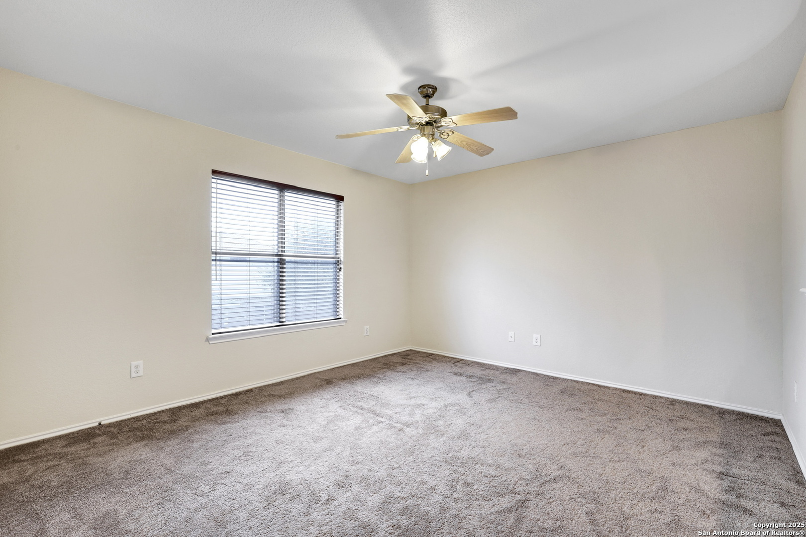 10410 Weser Lane Helotes, TX 78023 - Photo 19 of 22 an empty room with windows and fan
